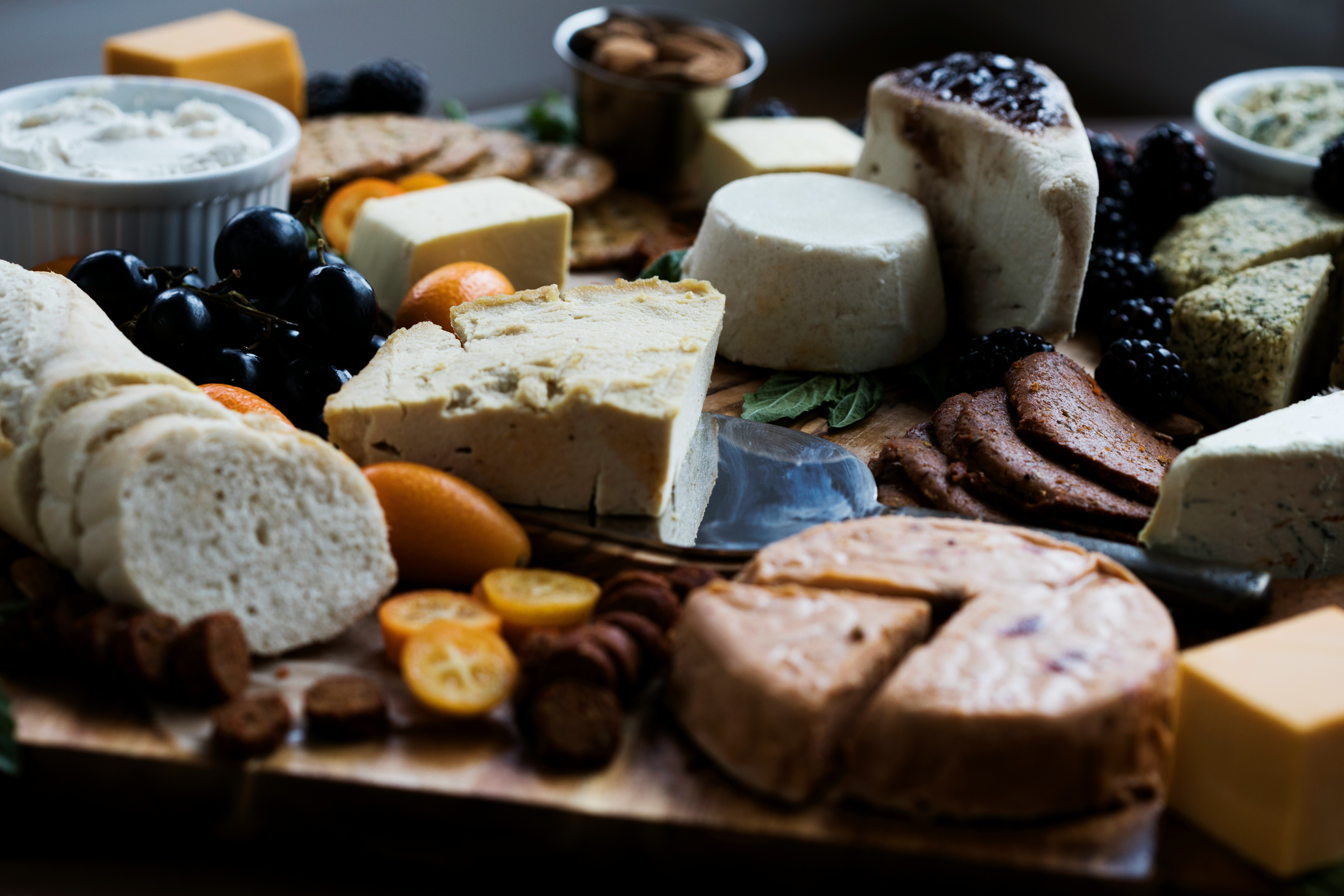A wooden board with a selection of cheeses